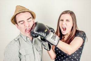 woman punching man in an argument introducing an article about the best books on conflict resolution
